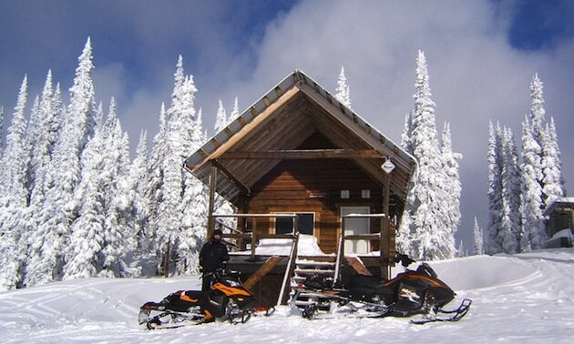 Snowmobiles parked outside the Blue Lake cabin