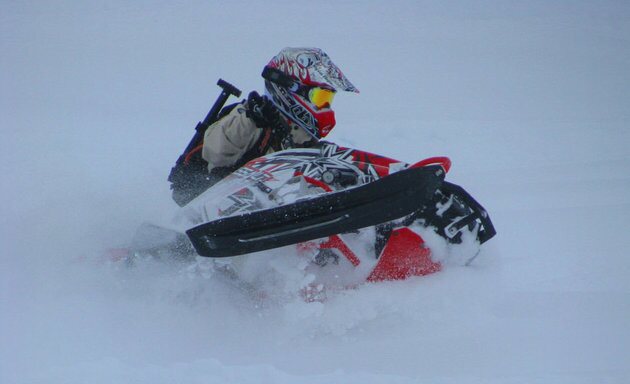 A rider buried to the handlebars in deep powder near Revelstoke
